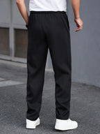 Men's black pleated trousers for layering through autumn and winter