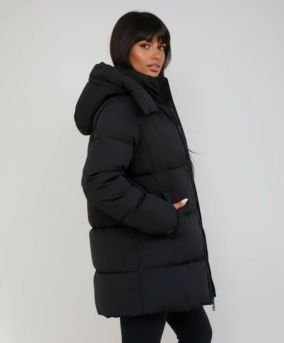 Women's black longline puffer jacket with hood for cold weather wear
