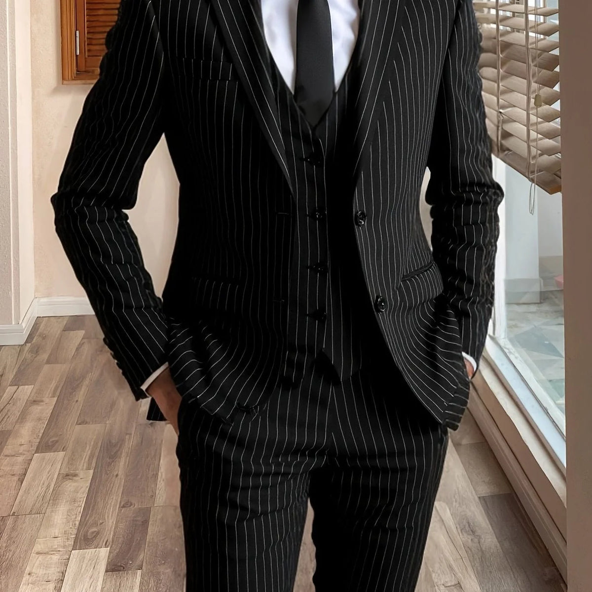 Men's dark green tailored pinstripe three-piece suit in autumn and winter