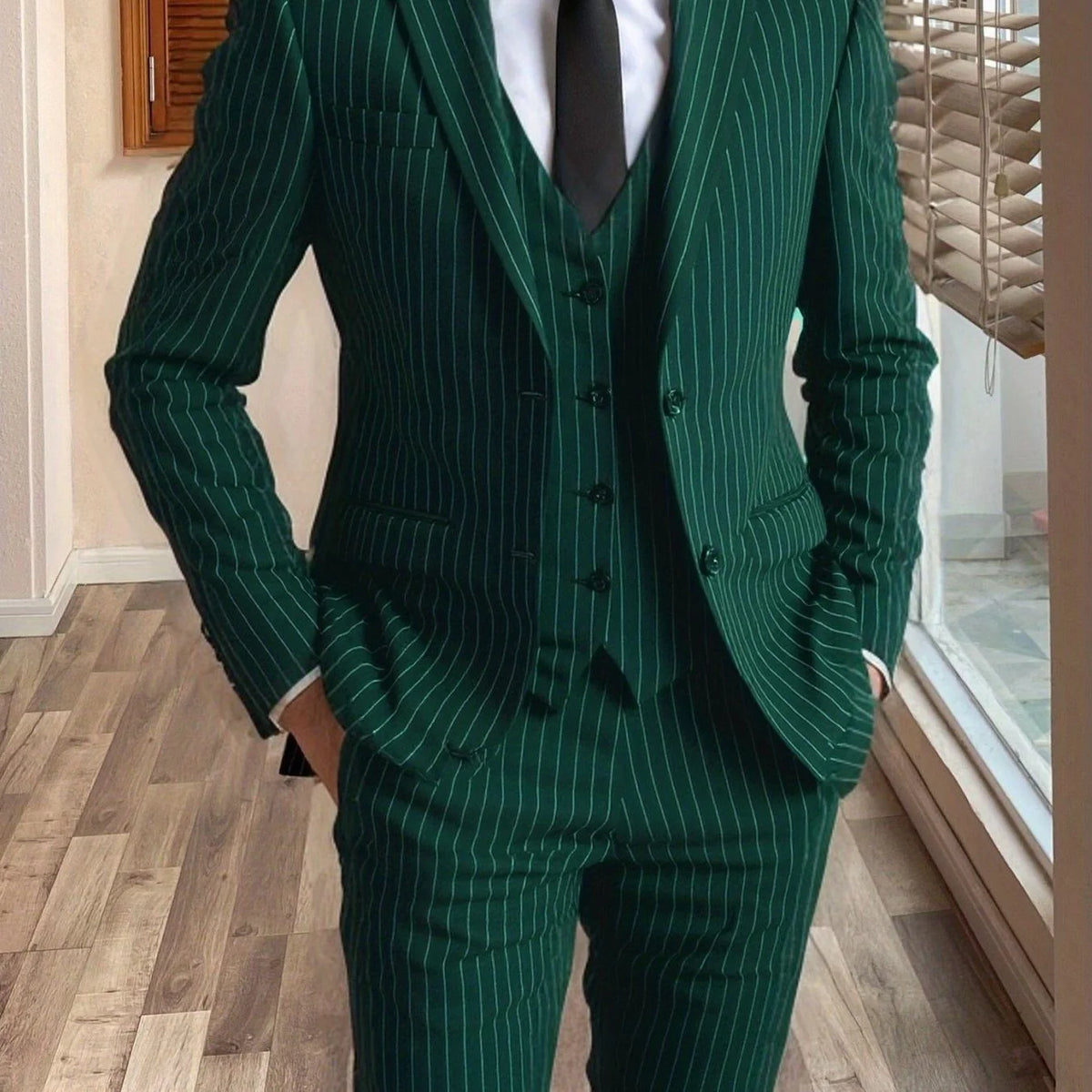 Men's dark green tailored pinstripe three-piece suit in autumn and winter