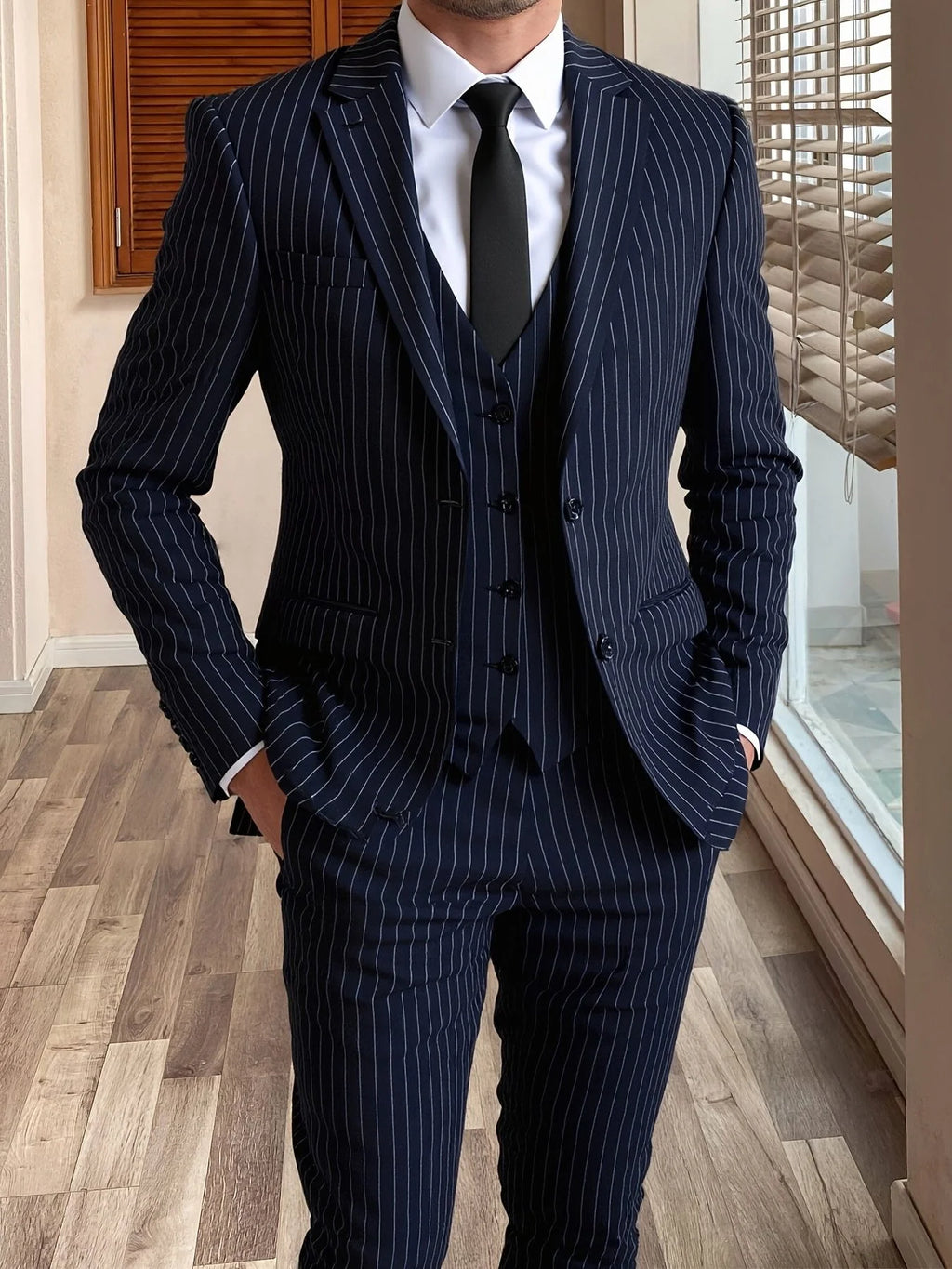 Men's black tailored pinstripe three-piece suit in autumn and winter