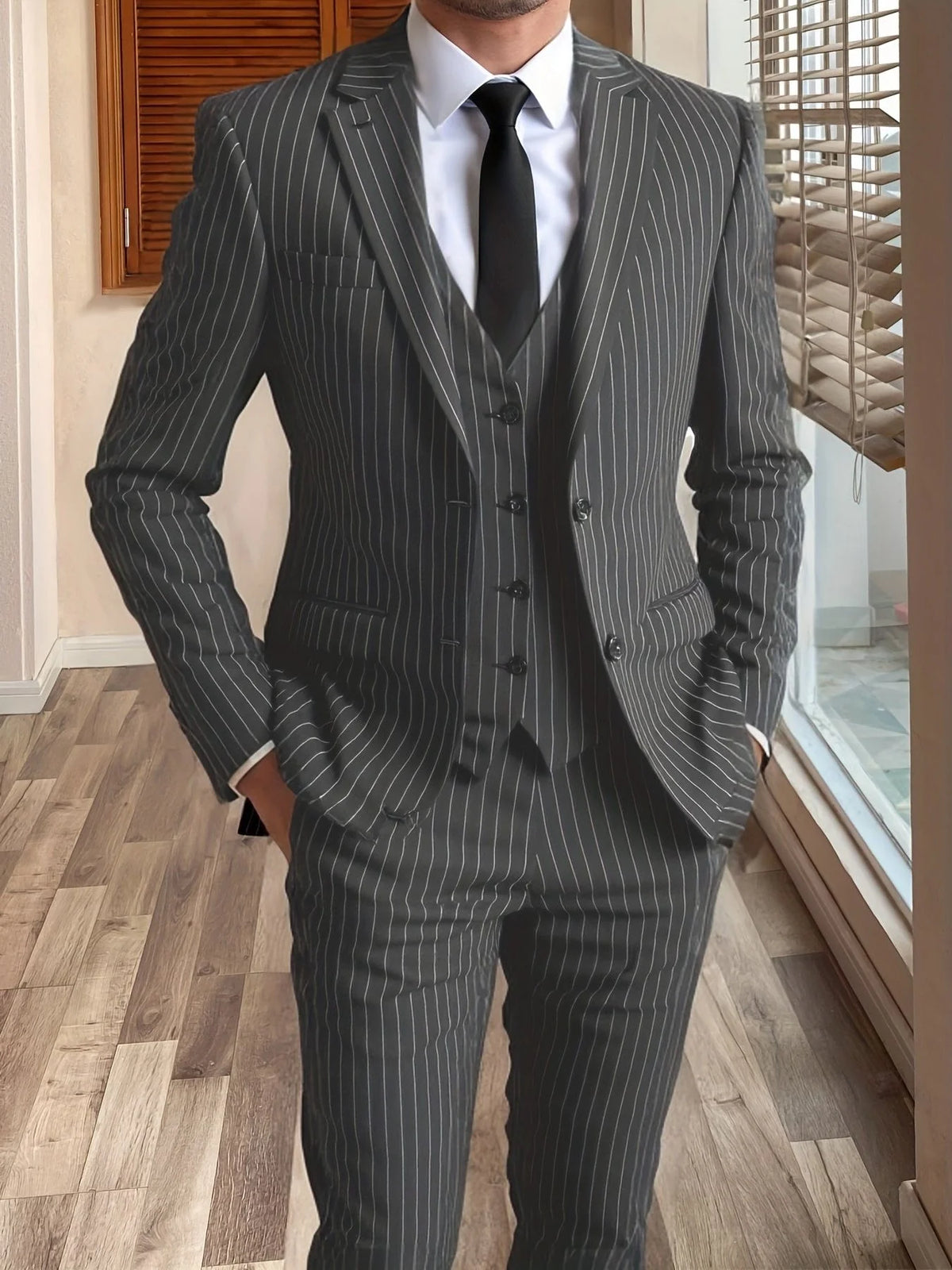 Men's grey tailored pinstripe three-piece suit in autumn and winter