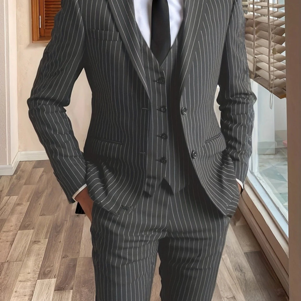 Men's dark green tailored pinstripe three-piece suit in autumn and winter