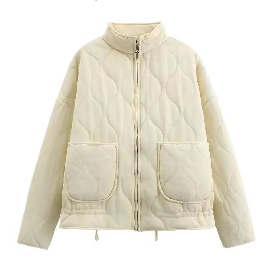 Women's ivory quilted zip-up jacket with welt pockets for layering