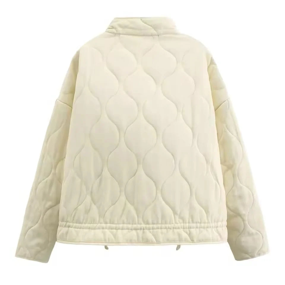 Women's ivory quilted zip-up jacket with welt pockets for layering
