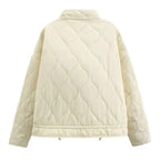 Women's ivory quilted zip-up jacket with welt pockets for layering