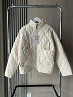 Women's ivory quilted zip-up jacket with welt pockets for layering