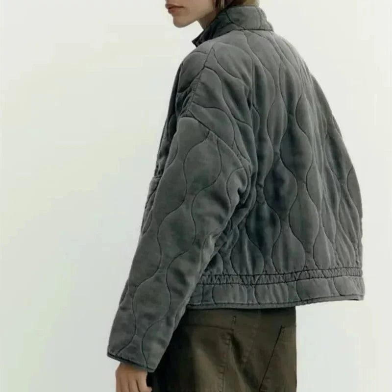 Women's olive green quilted zip-up jacket with welt pockets for layering