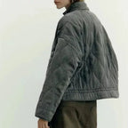Women's olive green quilted zip-up jacket with welt pockets for layering