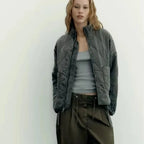 Women's olive green quilted zip-up jacket with welt pockets for layering