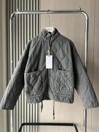 Women's dark grey quilted zip-up jacket with welt pockets for layering