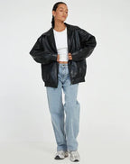 Women's black oversized leather jacket with collar for the season